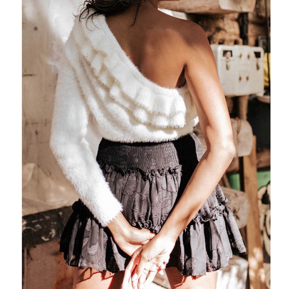 Cream colored one-shoulder ruffled sweater